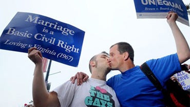 David Herman, right, kisses Jeff Hannan while celebrating a federal judge's decision overturning California's same-sex marriage ban on Wednesday, Aug. 4, 2010, in San Francisco. Chief U.S. District Judge Vaughn Walker made his ruling in a lawsuit filed by 