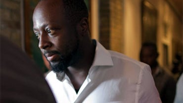 Haitian-born singer and presidential candidate Wycleaf Jean, second left, walks surrounded by security after Haiti's Electoral Council rejected his presidential candidacy in Port-au-Prince, Haiti, Friday, Aug. 20, 2010. The council's spokesman Richard Dum 
