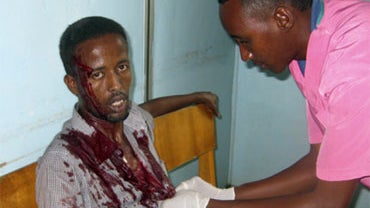 A nurse at Medina hospital treats a wounded civilian,at Medina hospital, Mogadishu, Somalia, Tuesday, Aug. 24, 2010. 