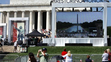 People start to gather at the site of the Restoring Honor rally by the Lincoln Memorial in Washington, on Friday, Aug. 27, 2010. The rally will take place on Saturday. (AP Photo/Jacquelyn Martin) 