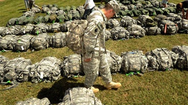 A soldier with the Bravo company of the 1st battalion, 116th infantry regiment collects his bags at the Hines Memorial Armory in Lexington, Va. on Wednesday, Aug. 25, 2010, after returning home from Iraq. 
