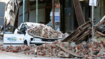 A car damaged by rubble from a building is seen following a 7.4-magnitude earthquake in central Christchurch, New Zealand, early Saturday, Sept. 4, 2010. A powerful 7.4-magnitude earthquake struck much of New Zealand's South Island early Saturday. No tsun 