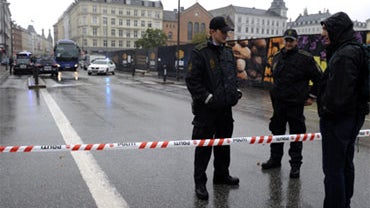 Police guard a cordon in central Copenhagen, Friday, Sept. 10, 2010, after it was suspected that the man  tried to detonate a small bomb in Hotel Joergensen in central Copenhagen. 