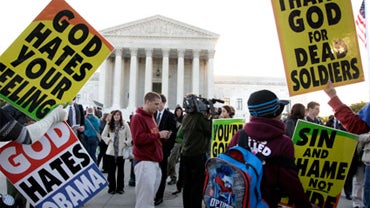 Members of the Westboro Baptist Church picket in front of the Supreme Court  