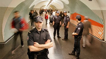 A French police patrol takes part in the stop-and-search of a passenger in the Metro station at the Gare du Nord, October 6, 2010 in Paris, France. 