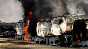 Trucks carrying fuel for NATO forces in Afghanistan burn following an attack by militants in the remote Mitri area, 112 miles southeast of Quetta, the capital of oil and gas rich Baluchistan province on October 9, 2010.  