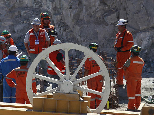  Workers at the San Jose mine set the covered entrance to the tunnel, center back, that was drilled for the rescue operation of the 33 trapped miners near Copiapo, Chile, Monday, Oct. 11, 2010. Rescuers on Monday finished reinforcing the hole drilled to b 