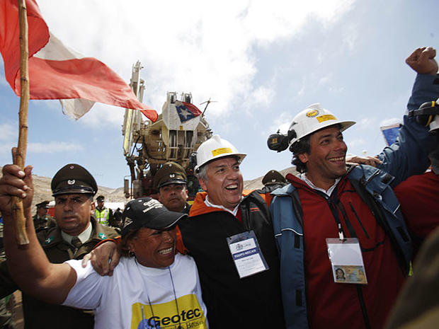Maria Segovia, sister of trapped miner Dario Segovia, front left, embraces unidentified T-130 drill operators who helped make the hole that reached 33 trapped miners in the San Jose mine near Copiapo, Chile, Monday Oct. 11, 2010. The engineer leading Chil 