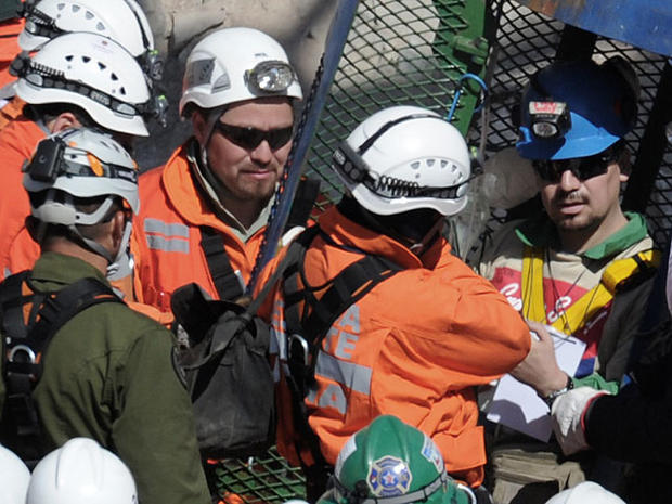 Chilean miner Edison Pena (R) leaves the Fenix capsule after being brought to the surface in the twelfth place, on October 13, 2010 following a 10-week ordeal in the collapsed San Jose mine, near Copiapo, 800 km north of Santiago. AFP PHOTO/ Rodrigo ARANG 