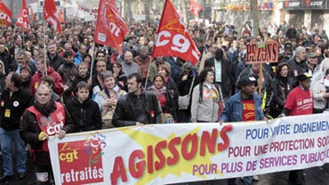 People hold a banner reading "Let's act" during a demonstration against the French governmental pensions reform on October 16, 2010 in Paris. 