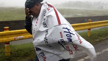A resident braves the strong winds and heavy rains at the onslaught of typhoon Megi (local name "Juan") Monday Oct.18, 2010 at Cauayan, Isabela province in northeastern Philippines. The strongest cyclone in years to buffet the Philippines knocked out comm 