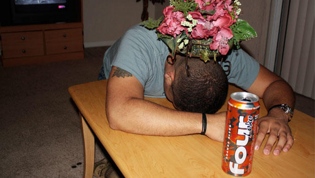 Man passed out with Four Loko in the foreground. 