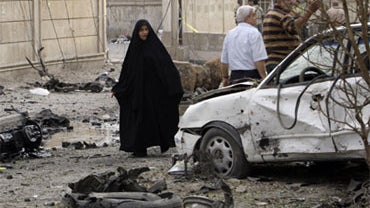 Iraqis react at the scene of a car bomb attack in front of a Syrian Catholic Church, in Baghdad, Iraq, Monday Nov. 1, 2010. 