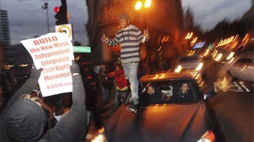 Demonstrators jump on cars during street protests in reaction to the conviction of Bay Area Rapid Transit police officer Johannes Mehserle in Oakland, Calif., Friday, Nov. 5, 2010. 