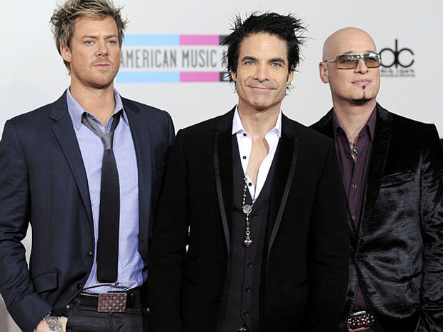 The band Train, from left, Scott Underwood, Patrick Monahan, and Jimmy Stafford arrive at the 38th Annual American Music Awards on Sunday, Nov. 21, 2010 in Los Angeles. (AP Photo/Chris Pizzello) ________________________________________ 