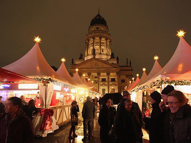 : Visitors walk through the Christmas Market at Gendarmenmarkt on its opening day on November 22, 2010 in Berlin, Germany. The Christmas Market at Gendarmenmarkt is among the city's most traditional Christmas markets. (Photo by Sean Gallup/Getty Images 