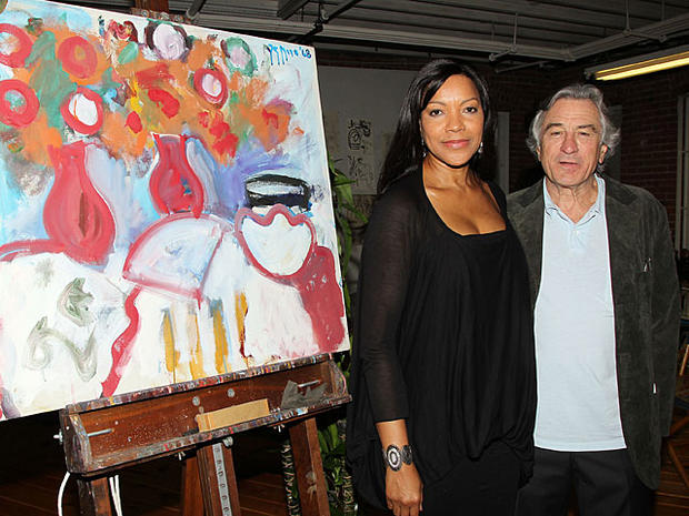In this photo released by Starpix, actor Robert De Niro, and his wife, Grace Hightower, stand next to a painting executed by his father, Robert De Niro Sr., Wednesday, Nov. 17, 2010 in New York. At the private event hosted by the Tribeca Film Institute, D 