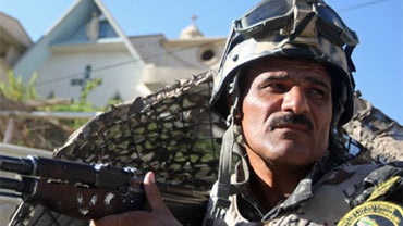 An Iraqi police commando stands guard outside the Virgin Mary church in Baghdad on November 5, 2010 as Iraqi forces impose heavy security measures following the October 31 deadly hostage drama inside a church in the war-torn capital. 