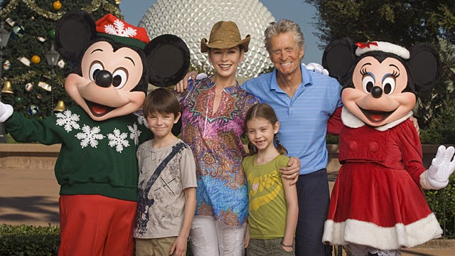 ickey Mouse and Minnie Mouse pose with actors Catherine Zeta-Jones and Michael Douglas and their children, Dylan, 10, left, and Carys, 7, in front of the Epcot theme park Christmas tree in Lake Buena Vista, Fla., on Wednesday, Nov. 24, 2010.  