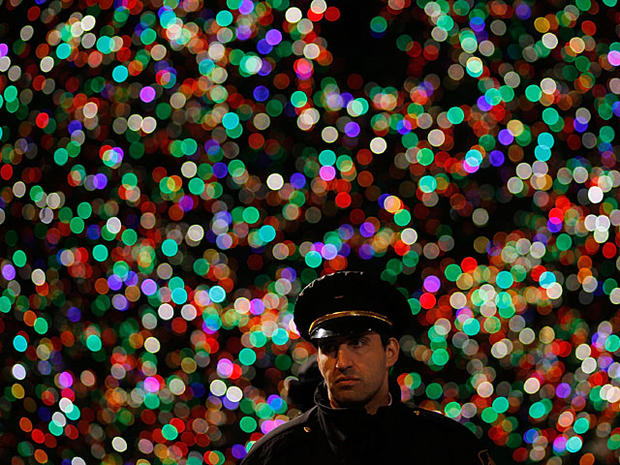 : A security guard stands in front of the Rockefeller Center Christmas Tree after the annual lighting ceremony November 30, 2010 in New York City. (Photo by Chris Hondros/Getty Images)  