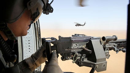 U.S. Army Sgt. Cal Kearl of Show Low, Ariz., provides cover for a medevac helicopter from a chase helicopter as part of Task Force Shadow of the 101st Combat Aviation Brigade Oct. 2, 2010, near Marja, Afghanistan. A chase helicopter is responsible for sec 
