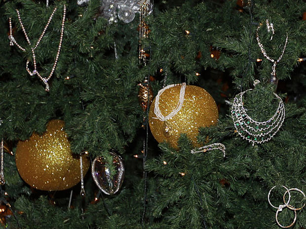 Golden necklaces are seen among the other decorations adorning a Christmas tree which has been decked out with dollars 11 million U.S. (14.3 million euro) worth of gold, at the Emirates Palace hotel, in Abu Dhabi, United Arab Emirates, on Thursday Dec. 16 