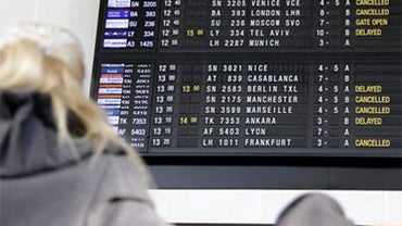 A passenger looks at a departure board at Zaventem airport Brussels on Monday, Dec. 20, 2010. Airports and trains across Europe are attempting get their transport up and running again after several days of severe weather blanketed the region. (AP Photo/Vi 