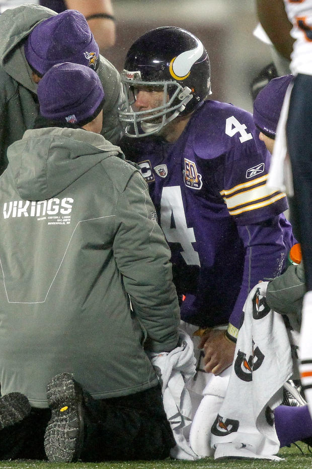 Quarterback Brett Favre #4 of the Minnesota Vikings is attended to after being sacked  