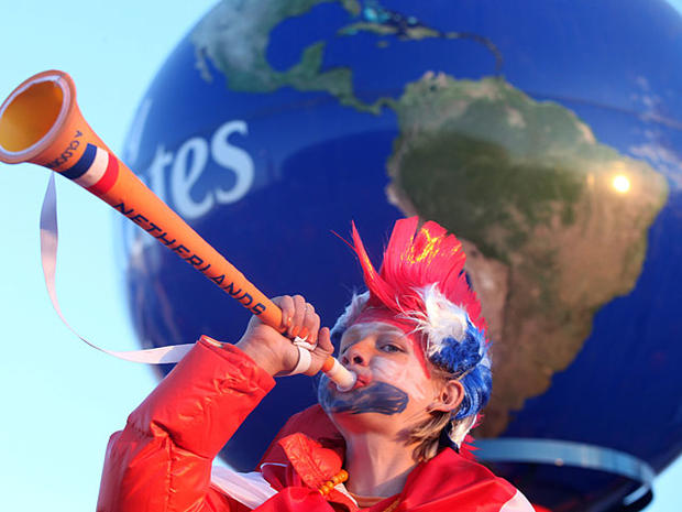  young supporter of the Netherlands blows a vuvuzela outside Soccer City stadium in Soweto, in suburban Johannesburg ahead of the 2010 World Cup football final between the Netherlands and Spain on July 11, 2010. AFP PHOTO / PABALLO THEKISO (Photo credit s 