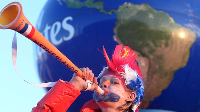  young supporter of the Netherlands blows a vuvuzela outside Soccer City stadium in Soweto, in suburban Johannesburg ahead of the 2010 World Cup football final between the Netherlands and Spain on July 11, 2010. AFP PHOTO / PABALLO THEKISO (Photo credit s 