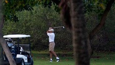 President Barack Obama plays a round of golf with friends Bobby Titcomb, Mike Ramos, and Eric Whitaker at the Kaneohe Klipper Golf Course at Marine Corps Base Hawaii on December 23, 2010 in Kaneohe, Hawaii.(Getty Images)  