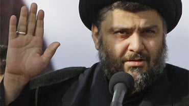 Shiite cleric Muqtada al-Sadr gestures during his first public appearance since returning from nearly four years of self-imposed exile in Najaf, south of Baghdad, Iraq, Saturday, Jan. 8, 2011.  