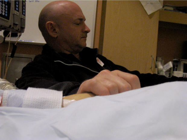 Mark Kelly holds the hand of his wife, Rep. Gabrielle Giffords, wife's hand at her bedside Sunday, Jan. 9, 2011, in the congresswoman's room at University Medical Center. 