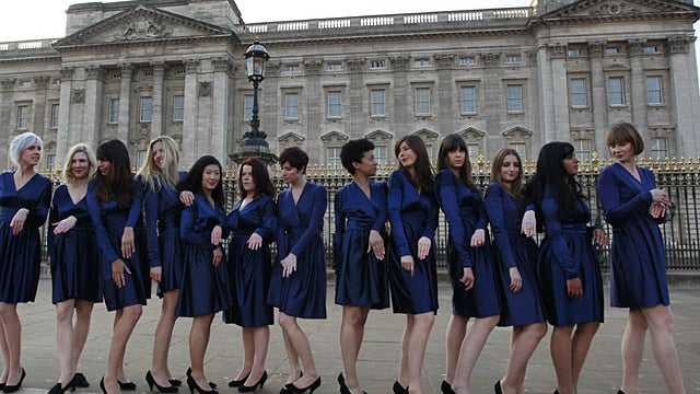 group of students from the Royal College of Art pose for photographs wearing Kate Middleton style engagement outfits they made themselves and engagement rings outside Buckingham Palace in London, Wednesday, Jan. 19, 2011. The group carried out the stunt f 
