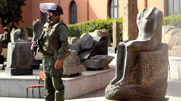 An Egyptian army soldier stands guard near antiquities of the Egyptian museum in Cairo, Egypt, Saturday, Jan. 29, 2011. 