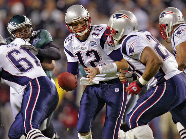 New England Patriots quarterback Tom Brady (12) hands the ball off to running back Corey Dillon 
