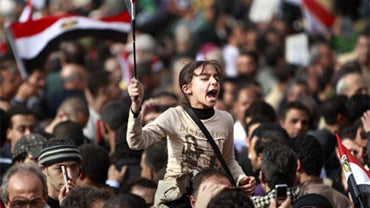 A young anti-government protester leads a call-and-response of anti-Mubarak chants at the continuing demonstration in Tahrir square in downtown Cairo, Egypt Friday, Feb. 4, 2011. Tens of thousands packed central Cairo Friday, waving flags and singing the  