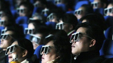 Audience members watch a movie through 3-D glasses at an IMAX theatre on February 8, 2007, in Wuhan, China. 