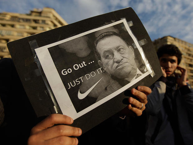 A protester holds a placard showing Egyptian President Hosni Mubarak  