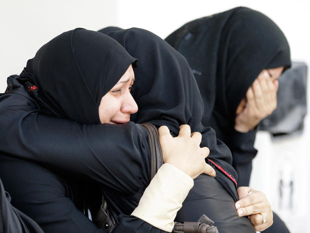 Bahraini women cry outside a hospital 