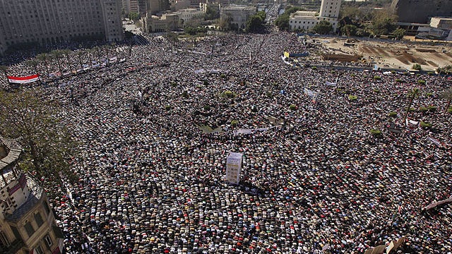 Tens of thousands of Egyptians pray and celebrate the fall of the regime of former President Hosni Mubarak 