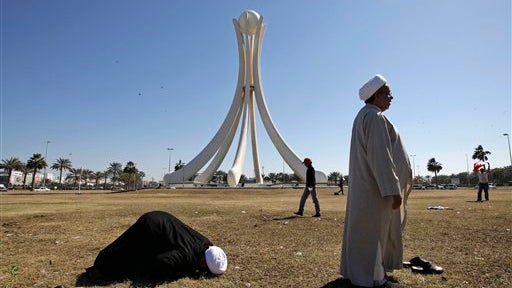 Bahraini clerics pray at the Pearl roundabout after the military pulled out 