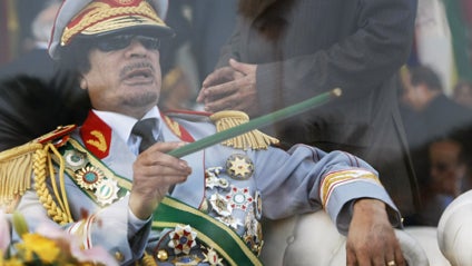 Libyan men celebrate in front of the camera as they assert victory over the country's leader Muammar Gadhafi in the city of Musaid in Libya, on the border with Egypt, on Feb. 22, 2011. 