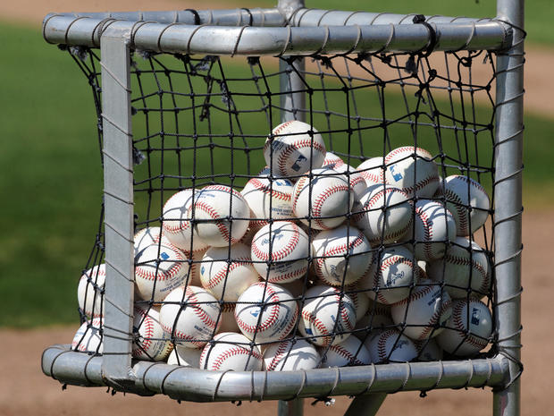 cart filled with baseballs 