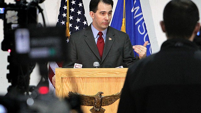 Gov. Scott Walker addresses the media during a news conference at Colgan Air Services at the La Crosse Municipal Airport in La Crosse, Wis. 