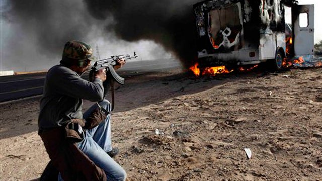 Militiaman guards Brega oil refinery 