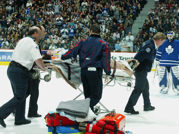 Brad May of the Canucks is removed from the ice on a stretcher with a concussion 