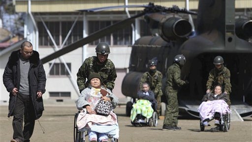 Japanese military personnel helping possible radiation exposure victims 