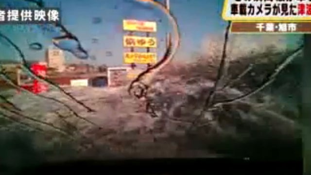 View from a dashboard camera as tsunami waves crash the coast of Japan 