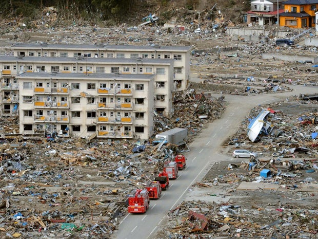 Firefighter trucks go through a residential area in the tsunami-stricken town of Onagawa in Miyagi Prefecture Saturday, March 19, 2011, eight days after the town was slammed by a powerful quake-triggered tsunami. (AP Photo/Kyodo News) JAPAN OUT, MANDATORY CREDIT, NO LICENSING IN CHINA, HONG KONG, JAPAN, SOUTH KOREA AND FRANCE 